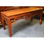 A Chinese elm altar table with carved and pierced apron, raised on square section legs.