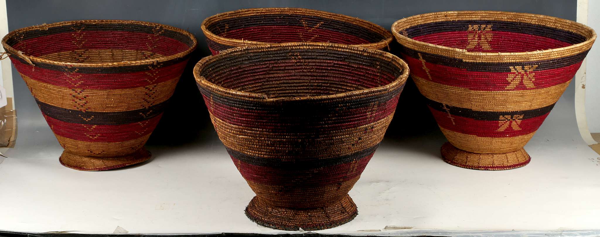 Set of 4 African tribal grass baskets, Ethiopia, largest 35cm diameter.