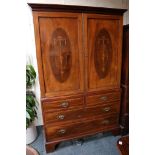 A "Sheraton Revival" mahogany linen press on a base of two short over two long drawers, raised on