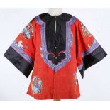 A 1900s Chinese silk embroidered child's traditional jacket, with very fine appliqué of dogs,