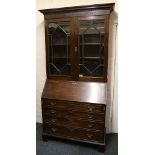 A Georgian mahogany bureau bookcase, the upper section with ogee pediment over a blind fret and