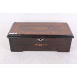 An 1880s wooden musical box playing eight Airs, the box having inlaid detail and chrome lock,