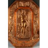 An octagonal repoussé copper dish with classical maiden, possibly Venus, surrounded by maidens.