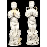 A PAIR OF CHINESE BLANC DE CHINE DEHUA BOYS. 
20th Century. 
Raised on a circular plinth with