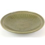 A LARGE CHINESE LONGQUAN CELADON DISH. 
Ming Dynasty. 
The interior is moulded with ribs, the