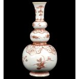 A TRIPLE GOURD ROUGE-DE-FER TRIPLE-GOURD VASE. 
Qing Dynasty, Kangxi period. 
Decorated with flowers