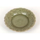 A CHINESE LONGQUAN CELADON GLAZED FOLIATE RIM DISH. 
Ming dynasty. 
Thickly potted and raised on a