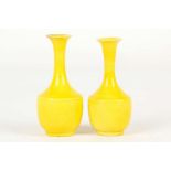 A PAIR OF CHINESE MONOCHROME YELLOW MINIATURE VASES. 
Late Qing. 
9cm H. (2) 
黄釉细颈小瓶一对