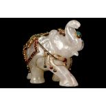 A ROCK CRYSTAL ELEPHANT. 
Nepal, 19th / 20th Century. 
Decorated with gilt copper filigree inlaid