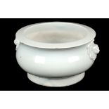 A CHINESE WHITE GLAZED CENSER WITH MASK HANDLES. 
Qing Dynasty, probably 18th Century. 
Of