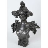 An Art Nouveau patinated spelter bust modeled as a young woman with flowers in her hair, (46cm