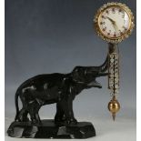 A decorative novelty clock with a one piece swinging clock/pendulum set with bright paste stones,