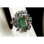 An 18ct white gold, emerald and diamond cluster dress ring.