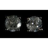 A pair of 18ct white gold and diamond stud earrings (diamond 0.58ct).