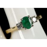 An 18ct gold, emerald and diamond three stone ring (emerald 0.59ct, diamond 0.29ct).