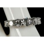 An 18ct white gold, large ring set with seven graduated diamonds (2.94cts).
