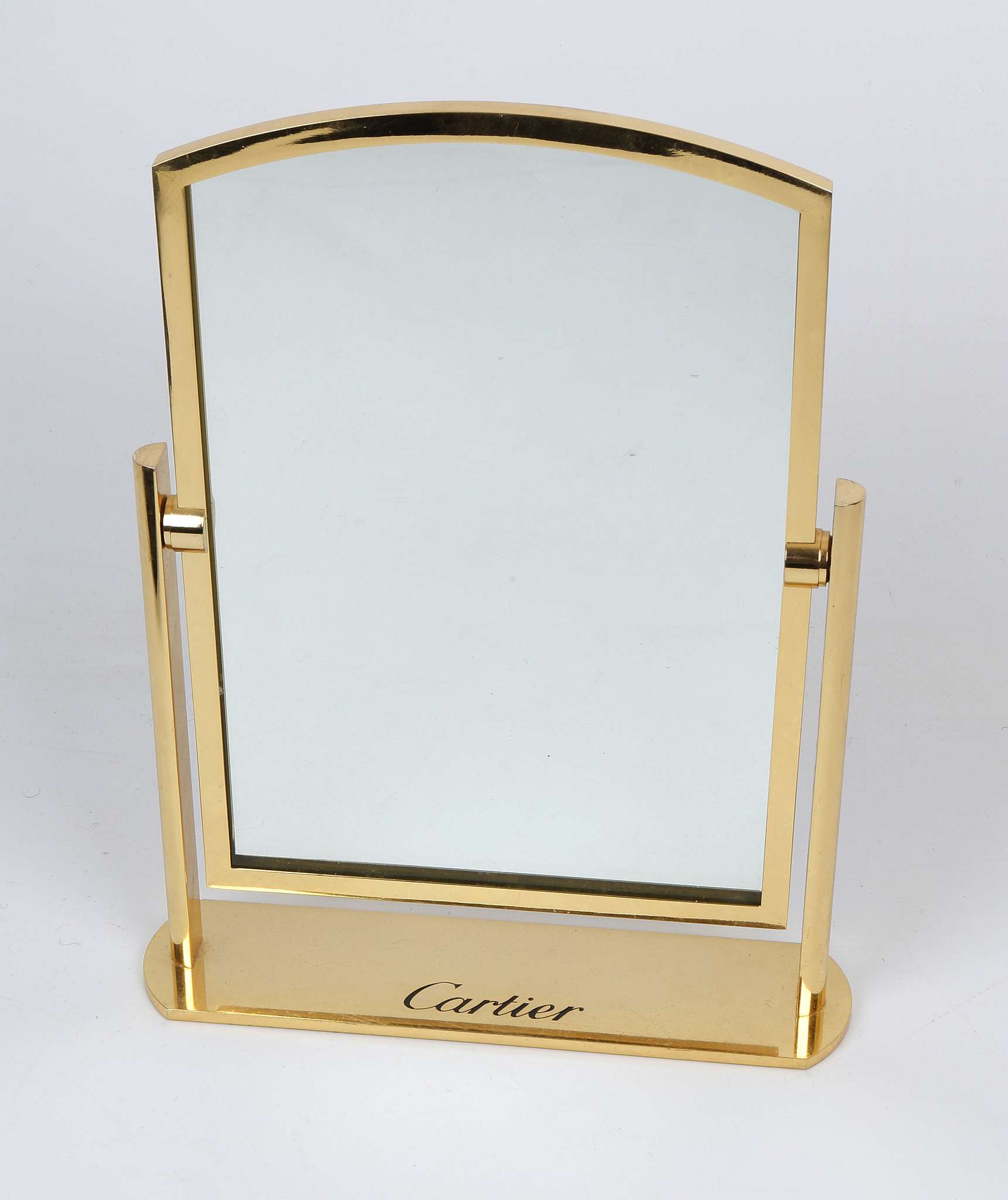 A  Cartier table mirror, gilt bronze tilting mirror, stamped Cartier, (34cm high).