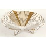 A WMF silver plate and gilt metal dish, raised on three feet, stamped 'Silver Plate, Ikora Germany',