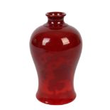 Bernard Moore Pottery, a slender ovoid vase with everted rim, covered in rich flambe glazes and