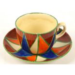 A Clarice Cliff tea cup and saucer in Original Bizarre pattern, painted in colours, stamped marks