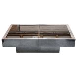 A 1970's Willy Rizzo coffee table, the mirrored glass top with polished steel surround, which slides