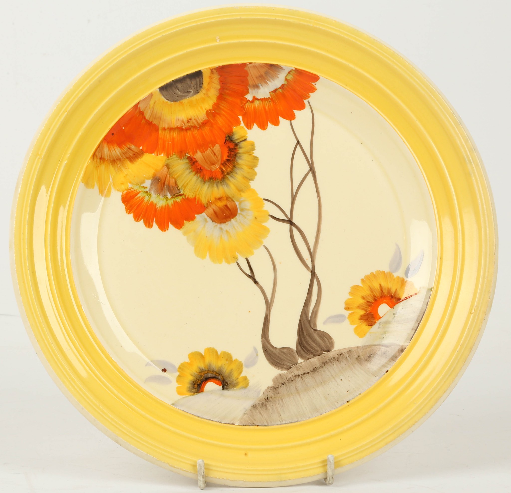 A Clarice Cliff Bizarre 'Rhodanthe' charger, painted in colours, (25.5cm diameter).