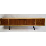 A 1960s room divider sideboard, possibly Conran, beech wood with walnut door and drawer fronts, on