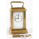 A miniature gilt brass and five glass carriage clock, white enamelled face, black Roman numerals and