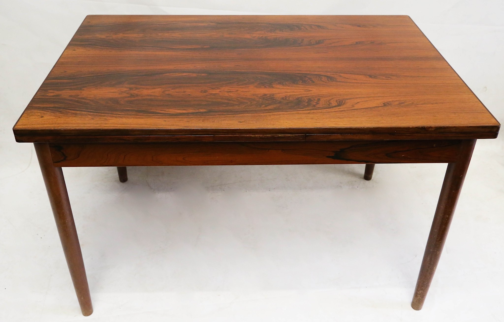 A 1960s Danish rosewood extending dining table, with a pull out leaf at each end, (121 x 80 x 76cm