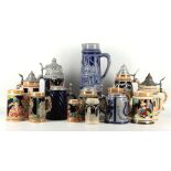 A collection of 14 various German stoneware beer steins, including some with pewter hinged lids (