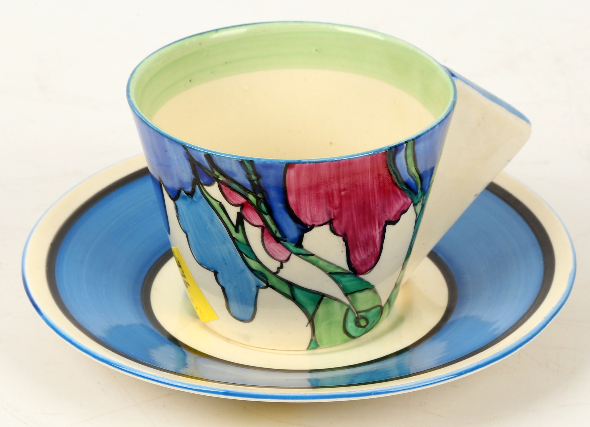 A Clarice Cliff Bizarre 'Rudyard' pattern conical cup and saucer, painted in colour, (cup; 5.5cm