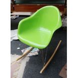 A Charles Eames style green shell chair on rocker base