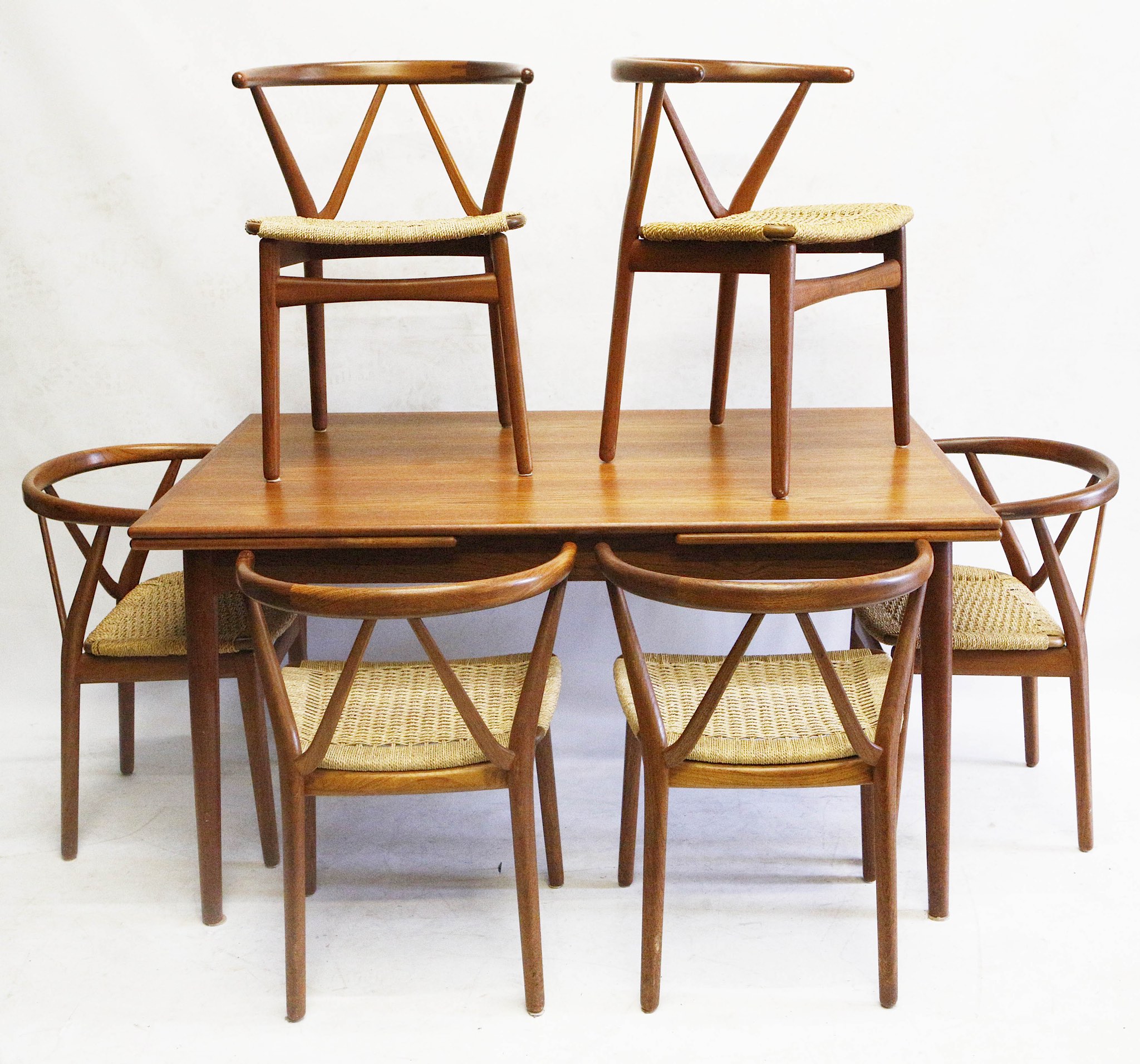 A 1960s Danish teak dining table and six model 225 chairs, designed by Henning Kjaernulf and