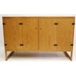 Børge Mogensen for P. Lauritsen & Son, an oak sideboard, model BM 57, with bi fold doors and brass