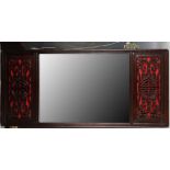 A Chinese mirror in a rosewood frame, the mirror flanked by a pair of carved reticulated panels with