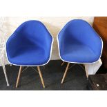 A pair of Charles Eames style white shell chairs with blue upholstery on wooden dowel base