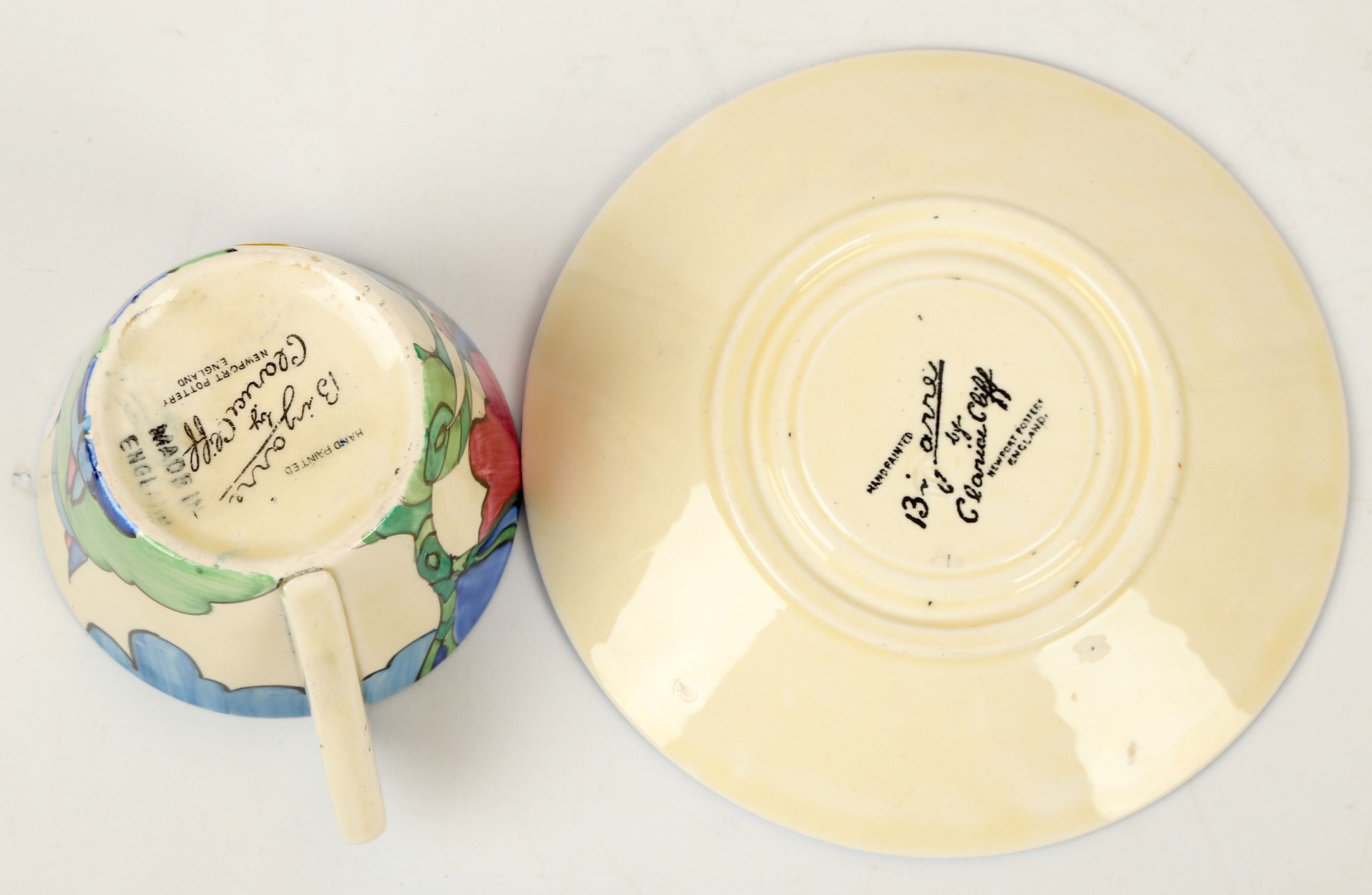 A Clarice Cliff Bizarre 'Rudyard' pattern conical cup and saucer, painted in colour, (cup; 5.5cm - Image 4 of 4