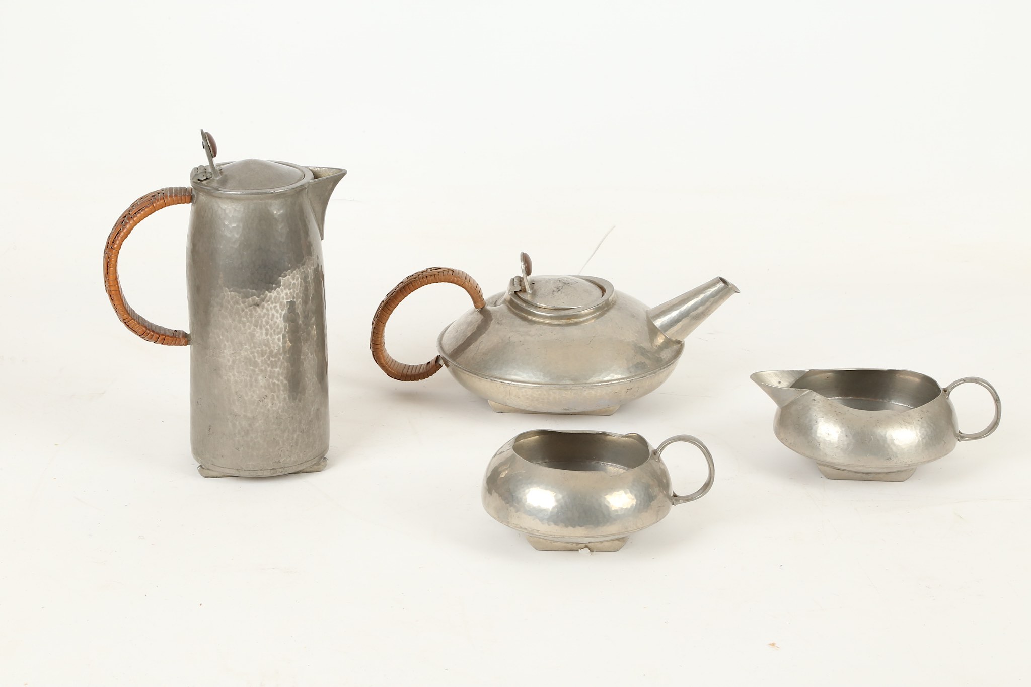 Archibald Knox for Liberty & Co., a pewter four piece tea set, consisting of a tea pot, hot water