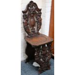 A pair of 18th Century style hall chairs, scallop and face of the wind flanked by caryatid semi-nude