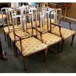A set of ten beech and gilt decorated dining chairs, including two carvers with stuff over seats