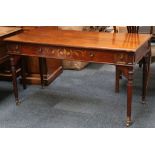 A Victorian mahogany writing desk by Howard & Sons, with inlaid central drawer (stamped on top of