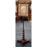 A 19th Century pole screen, rosewood scroll frame, floral tapestry with family gathering to