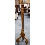 A carved and giltwood renaissance revival lamp standard, raised on scrolling acanthus supports