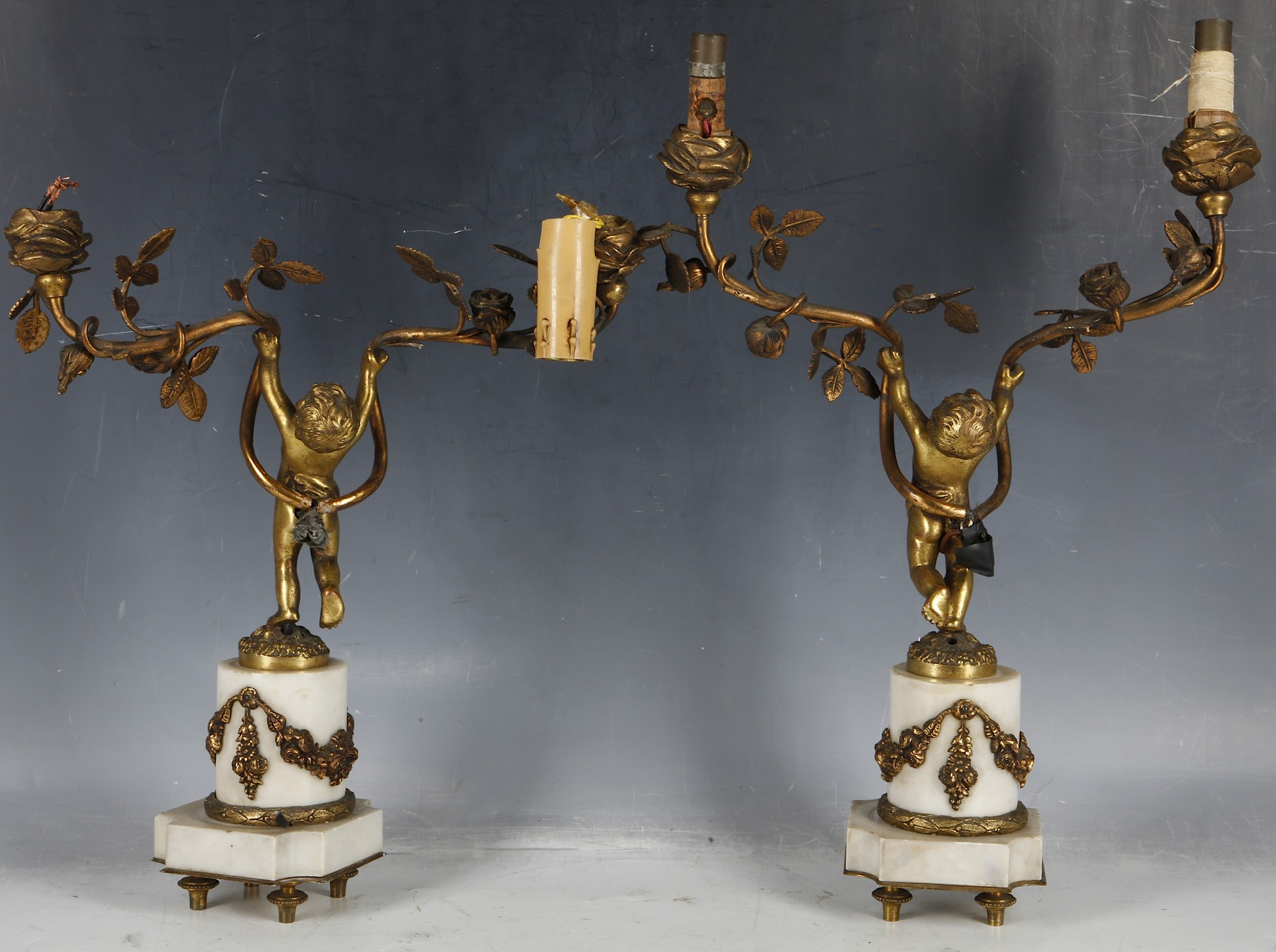 A pair of gilt metal two branch putti lights, putti mounted on white marble pedestal and plinth with - Image 2 of 2