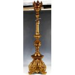 A large late 19th/early 20th century church candlestick on triform base, 1007cms high