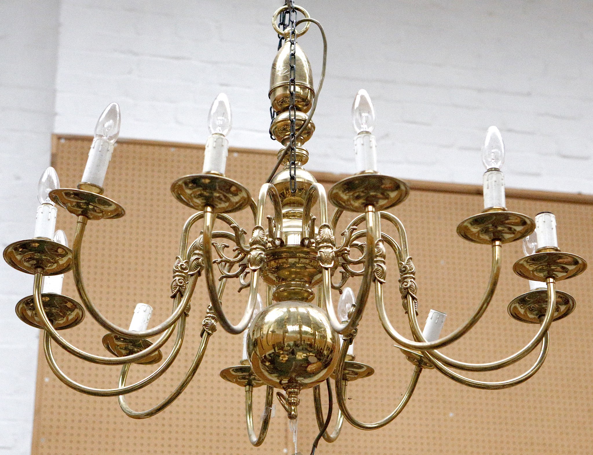 A Dutch style brass twelve branch chandelier sold with another brass chandelier with two tiered
