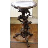 A continental blackamoor lamp table, mahogany circular top, leaf carving to edge, 50cm, tree form