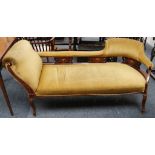 An Edwardian upholstered sofa with inlaid frame, one set back and the other a rolling arm