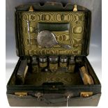A Mappin & Webb green leather ladies travelling case comprising hall marked silver toilet items,