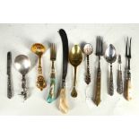 A collection of 17th, 18th and 19th century cutlery to include solid silver spoon figures with a